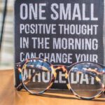 Positive Thinking - Photo of a Sign and Eyeglasses on Table