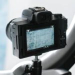Innovation Inspiration - Contemporary professional photo camera prepared for shooting