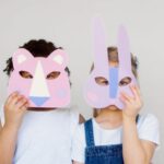 Innovative Mindset - Two Kids Covering Their Faces With a Cutout Animal Mask