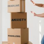 Creative Solutions - Man near carton boxes with many different words about stress
