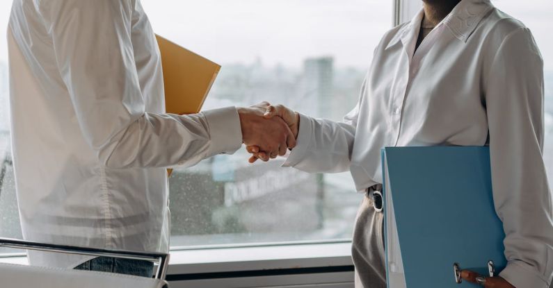 Business Etiquette - Business People Shaking Hands in Agreement