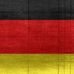 Understanding Global Trends - Grungy background designed as flag of Germany on shabby wooden board with measure scale