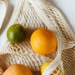 Reducing Distractions - Assorted citrus fruits in cotton sack on white surface