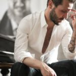 Personalization Experience - Dramatic tattooed male sitting at piano