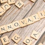 Innovative Solutions - The word innovation spelled out in scrabble tiles
