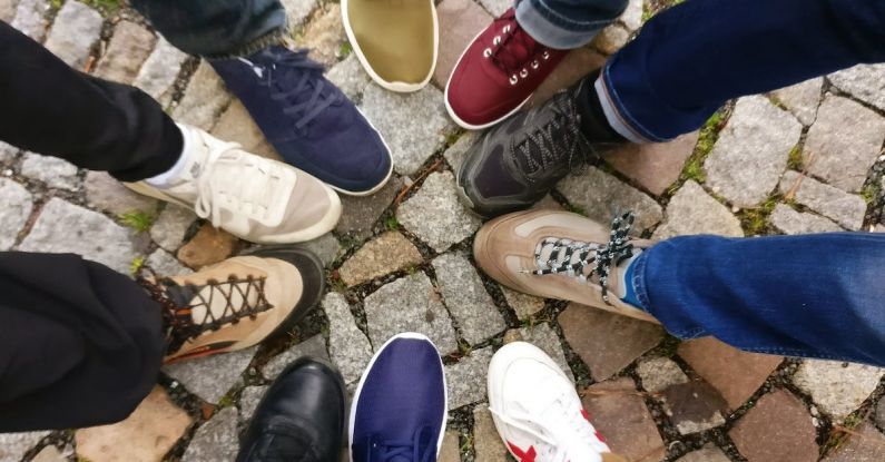 Brand Community - People Forming Round by Shoes