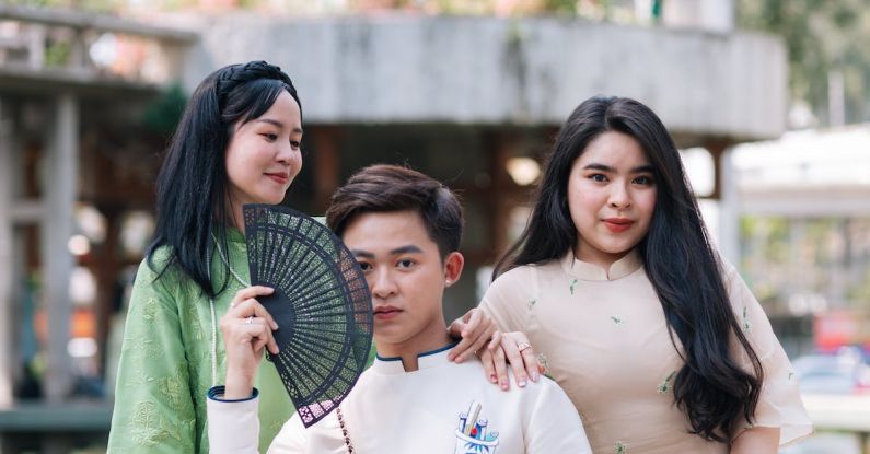 Culture Of Purpose - Three asian people posing for a photo with a fan