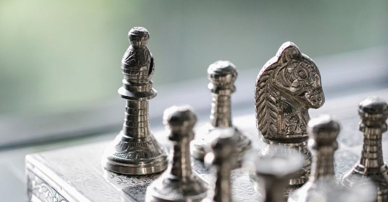 Strategy Challenges - Metal chess pieces on board in room