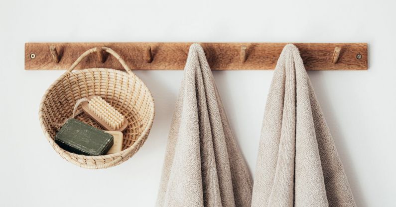 Sustainable Practices - Wooden hanger with towels and basket with bathroom products
